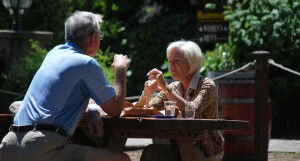 Senior couple sitting on bench and eating